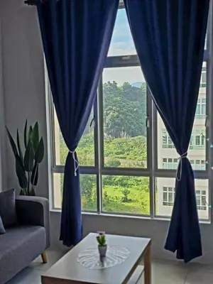 a living room with a large window with blue curtains at b02 The Anderson Ipoh Family Stay 2BR in Ipoh