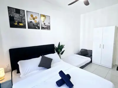a bedroom with a bed with a cross on it at d09 The Anderson Ipoh Family Stay 2BR in Ipoh
