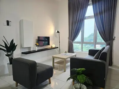 a living room with a couch and a table and a tv at d15 The Anderson Ipoh Family Stay 2BR in Ipoh