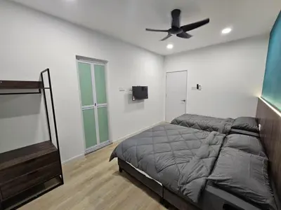 a bedroom with a bed and a ceiling fan at Roomstay KOBANAS in Ipoh