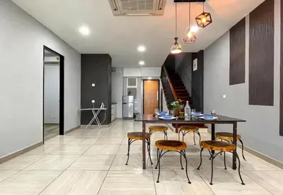 a kitchen and dining room with a table and chairs at Jomstay Octagon Ipoh Penthouse in Ipoh