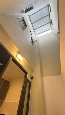 a hallway with a skylight in a building with a window at Ether 665 Homestay in Sekincan