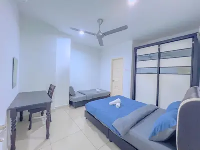 a bedroom with a bed and a table and a desk at 2BR SeaView Retreat At Mansion1 in George Town