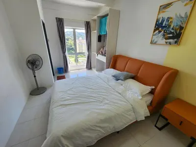 a bedroom with a large bed with an orange headboard at Cameron Highland 910 The Garden 3BR 6 Pax in Brinchang