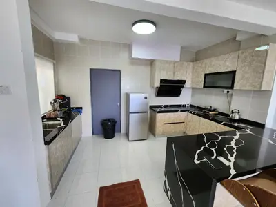 a kitchen with a sink and a refrigerator at Cameron Highland 910 The Garden 3BR 6 Pax in Brinchang