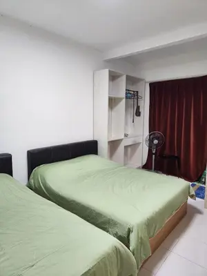 a bedroom with two beds with green sheets at Cameron Highland 623 London style 10pax in Brinchang