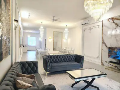 a living room with a couch and a table at Executive White Houze in Kepala Batas