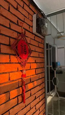 a brick wall with a red clock on it at 3 Bedrooms Single Storey Terrace at Taman Inderawasih ,12mins to Penang Bridge , 5mins to Sunway Carnival Mall in Butterworth