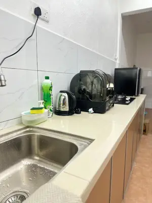 a kitchen counter with a sink and a microwave at 3 Bedrooms Single Storey Terrace at Taman Inderawasih ,12mins to Penang Bridge , 5mins to Sunway Carnival Mall in Butterworth