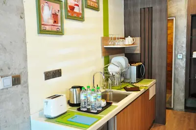 a kitchen with a sink and a microwave at Valya Hotel, Ipoh in Ipoh