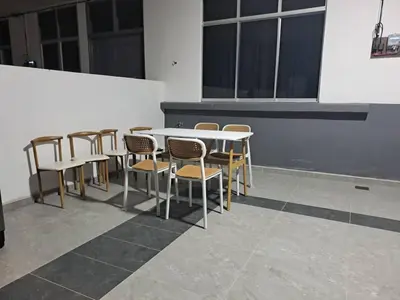 a group of tables and chairs in a room at Tiara Homestay Bandar Baru Kuala Lipis in Kuala Lipis