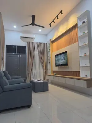 a living room with a couch and a tv at Tiara Homestay Bandar Baru Kuala Lipis in Kuala Lipis