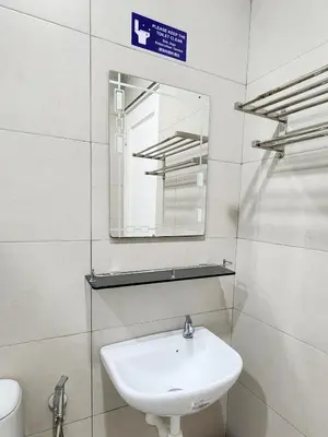 a bathroom with a white sink and a mirror at Georgetown Stay in George Town