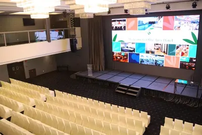 an auditorium with chairs and a large screen at Olive Tree Hotel Penang in Bayan Lepas