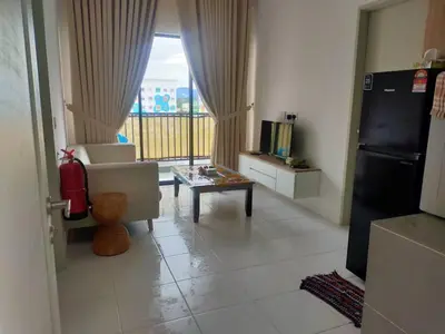 a living room with a couch and a table at Iskandar SmartStay in Kampong Bota Road