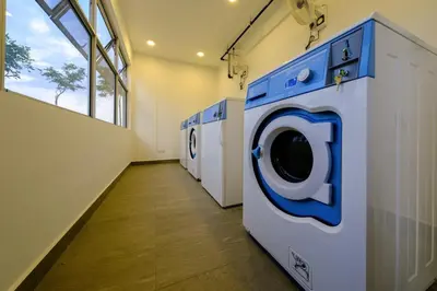 a row of washing machines in a laundry room at Penang Beachfront Seaview Residences in Tanjong Tokong