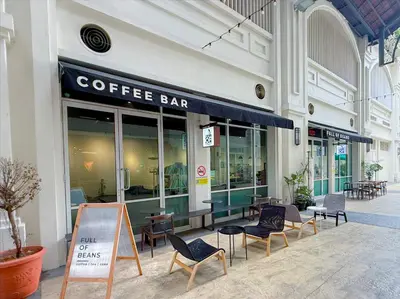a coffee bar on the side of a building at Straits Quay By The Marina 1BR Family Suite in Tanjong Tokong
