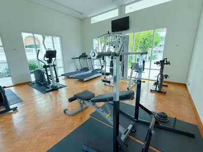 a gym with several tread machines in a room at Straits Quay By The Marina 1BR Family Suite in Tanjong Tokong