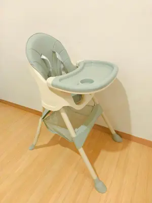 a white high chair sitting on top of a wooden floor at 118 Island Plaza Seaview Family Suite 5Pax 1Carpark in George Town