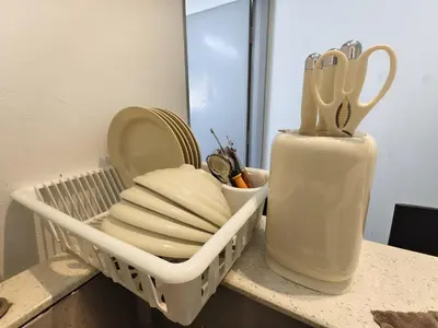 a dish rack with plates and utensils on a counter at Tanjung Bungah Holiday Home 4BR 20Pax 6Carpark in Tanjung Bungah
