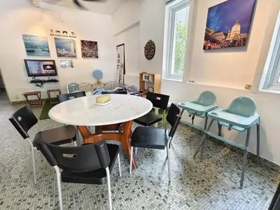 a dining room with a table and chairs at Tanjung Bungah Holiday Home 4BR 20Pax 6Carpark in Tanjung Bungah