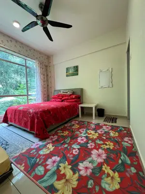 a bedroom with a bed with a red bedspread at Cameronian Lodge by AziziCameron in Tanah Rata