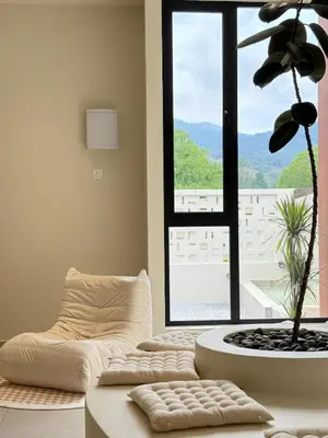 a living room with a couch and a large window at Taiping Corner Homestay in Taiping