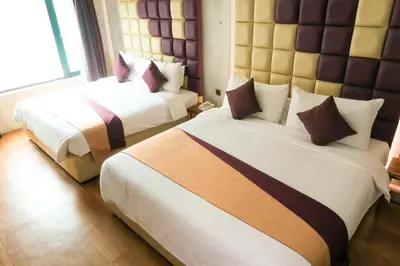 a hotel room with two beds and a large window at Le Dream Boutique Hotel in George Town