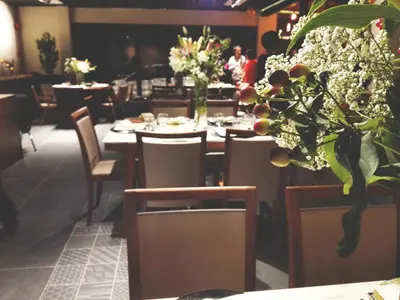 a dining room with tables and chairs and flowers at Le Dream Boutique Hotel in George Town