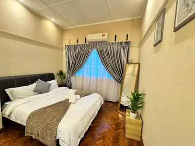 a small bedroom with a bed and a window at Greentown Villa - Ipoh City Centre near Ipoh Parade by IWH Suites in Ipoh