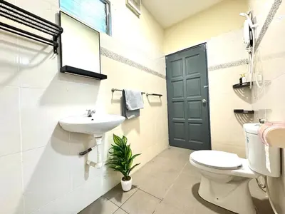 a bathroom with a white toilet and a sink at Greentown Villa - Ipoh City Centre near Ipoh Parade by IWH Suites in Ipoh