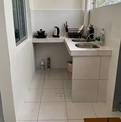 a small white kitchen with a sink and a window at EcoPutra Stay in Ipoh