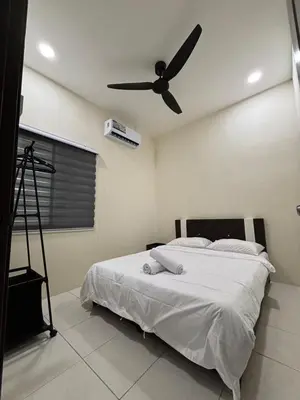a bedroom with a bed with a ceiling fan at EcoPutra Stay in Ipoh