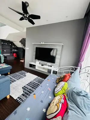 a bedroom with a bed with a television in it at AYAAN Foosball Penthouse at Golden Hill with Private Parking and Netflix in Brinchang