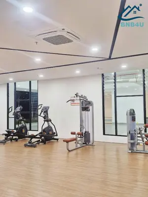 a gym with treadmills and exercise bikes in a room at Minimalist Dual-Key Stay with 4BR at Farlim Penang in Ayer Itam