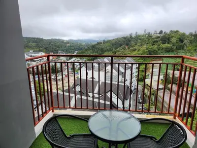 a balcony with a table and chairs and a view at Sweet Home G12 Emerald Avenue in Brinchang