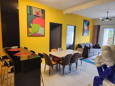 a dining room with a table and chairs in a room at 8-28 The Art Gallery Emeral Avenue in Brinchang