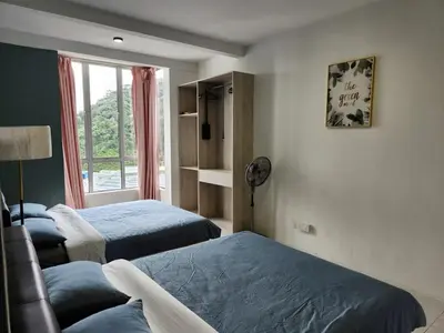 a bedroom with two beds and a window at 821 Camping Style in Brinchang