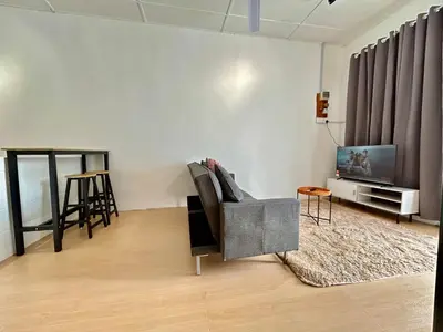 a living room with a chair and a tv at Cozyindah11A#7pax#netflix#NearAeonAlma#BukitMertajam in Bukit Mertajam