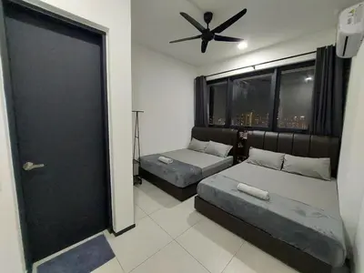 a bedroom with two beds and a ceiling fan at Urban Suites Penang by Dynaz Homestay in Jelutong