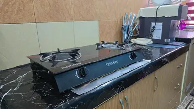 a kitchen counter with a stove top on a counter top at Azura Homestay Seri Iskandar in Seri Iskandar