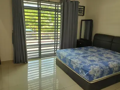 a bedroom with a bed and a large window at Adeline's Homestay Balik Pulau in Balik Pulau