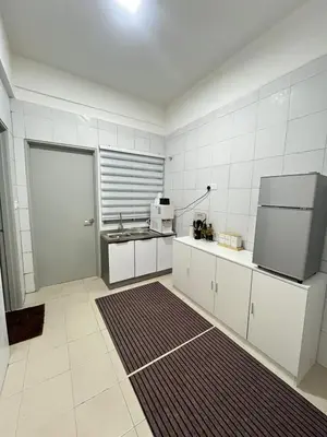 a white kitchen with a sink and a refrigerator at M Retreat Cameron Highlands in Tanah Rata