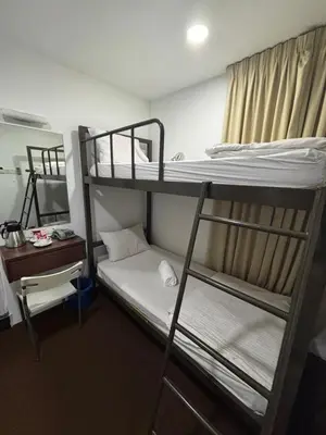 a dorm room with two bunk beds and a desk at Swing & Pillows - Grand Inn George Town Penang in George Town