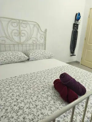 a stuffed animal is sitting on a bed at Rumah Huda in Bukit Mertajam