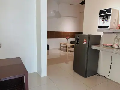 a kitchen with a stainless steel refrigerator with a microwave at Cozy Suite with Twin Beds & Lounge in Nibung Tebal