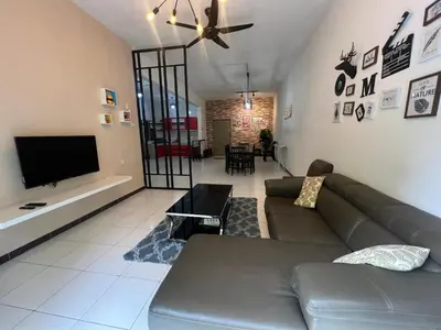a living room with a couch and a flat screen tv at StayIndah Homestay Cameron Highlands in Tanah Rata