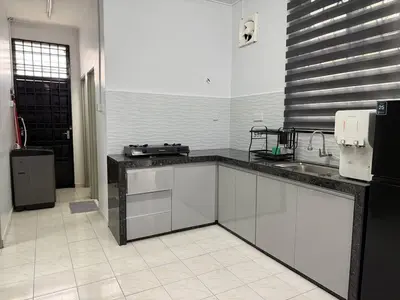 a kitchen with a sink and a counter top at Wareesha Homestay, Corner Lot With Netflix in Padang Serai