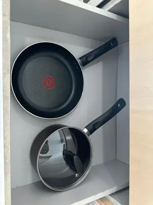 a frying pan and a mirror on a wall at Seaview Condo A31 #Queensbay#SPICE in Bayan Lepas