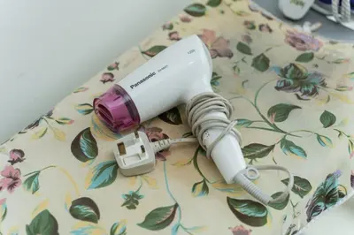 a white and purple electric toothbrush sitting on a table at Bright & Airy Double-Storey Retreat 4BR in Simpang Ampat
